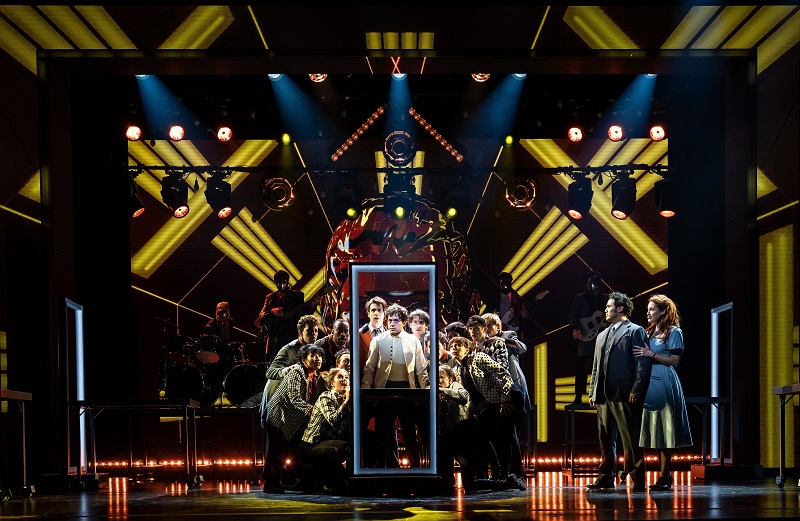 Ali Louis Bourzgui as Tommy Walker (center) joined by the company of The Who’s Tommy,with (far right) Tommy’s parents, Captain Walker (Adam Jacobs) and Mrs. Walker (Alison Luff) in The Who's Tommy Goodman Theatre