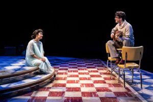 Molly Hernández and Keiran McCabe as Maria Elena and Buddy Holly playing guitar in the Buddy Holly Story at Marriott Theatre